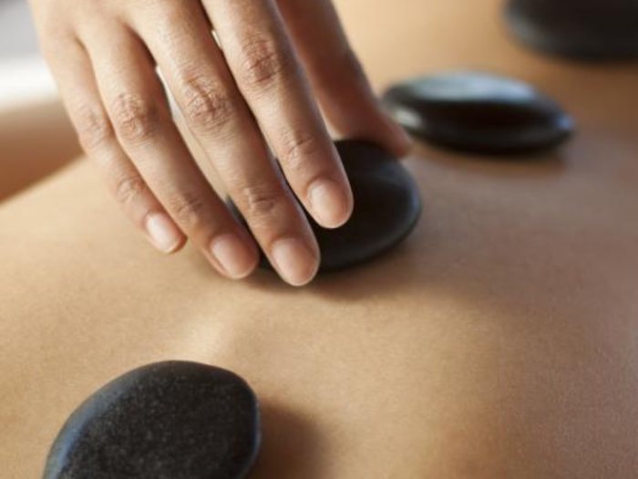 Warm stones on a client's back